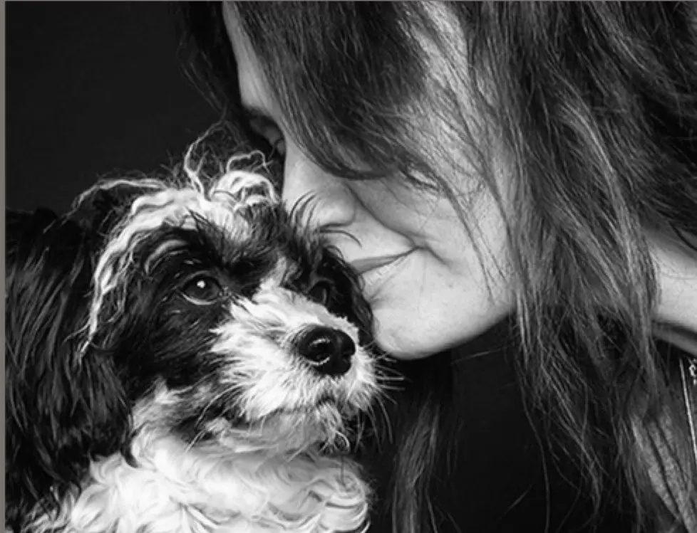 Lucie cuddling a small dog